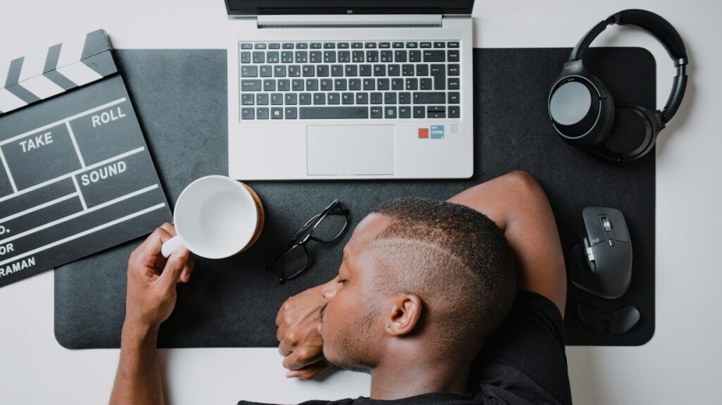 Tired man sleeping in front of computer